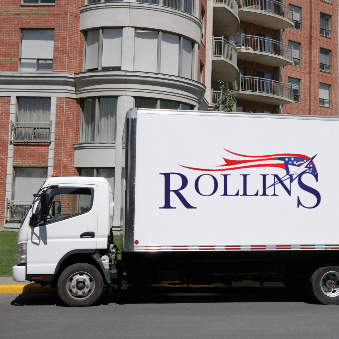 A white Moving Truck with Rollins Moving logo on the side.