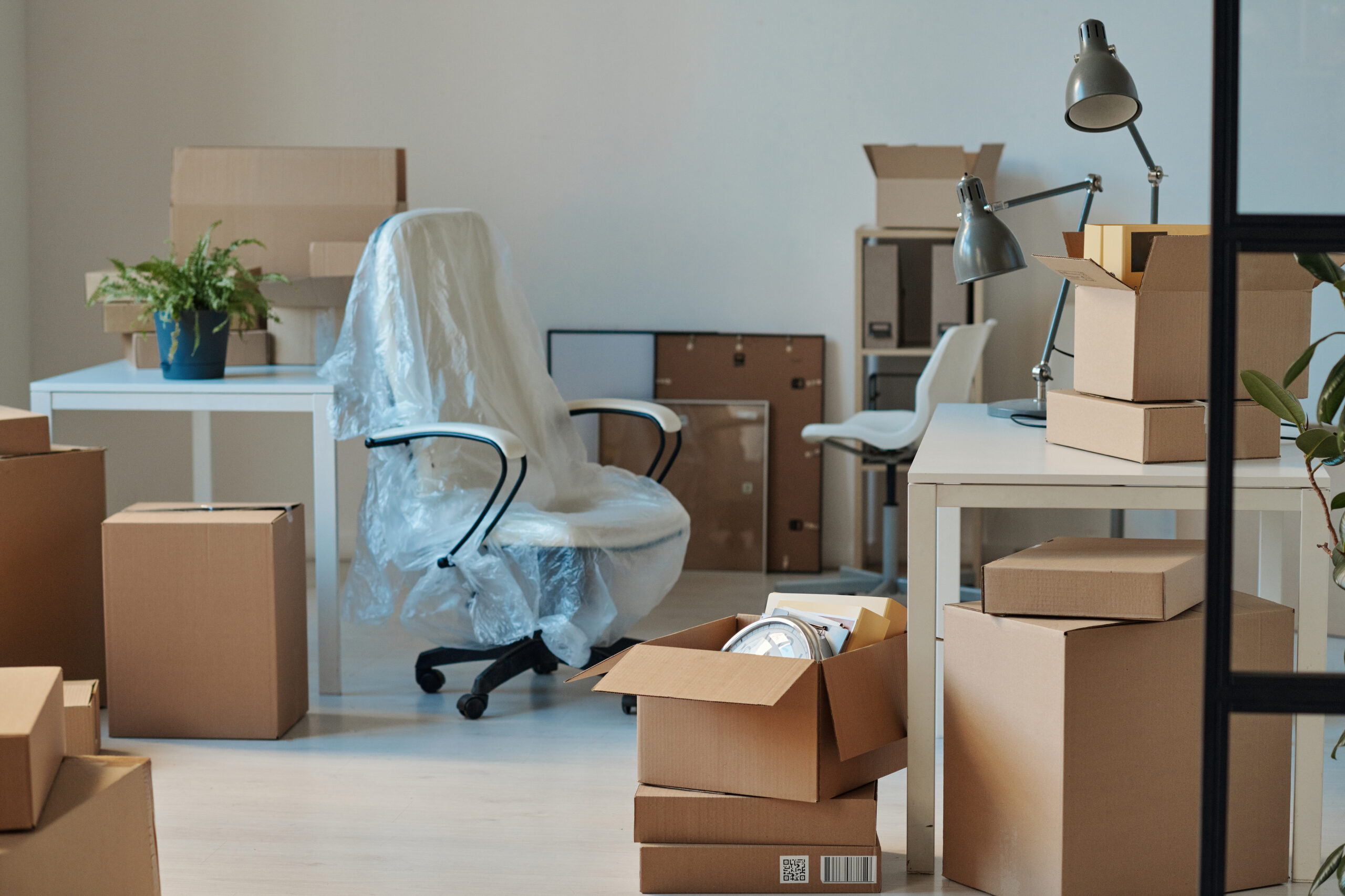 Office chair surrounded by packing boxes for Moving Services Near Dayton Ohio