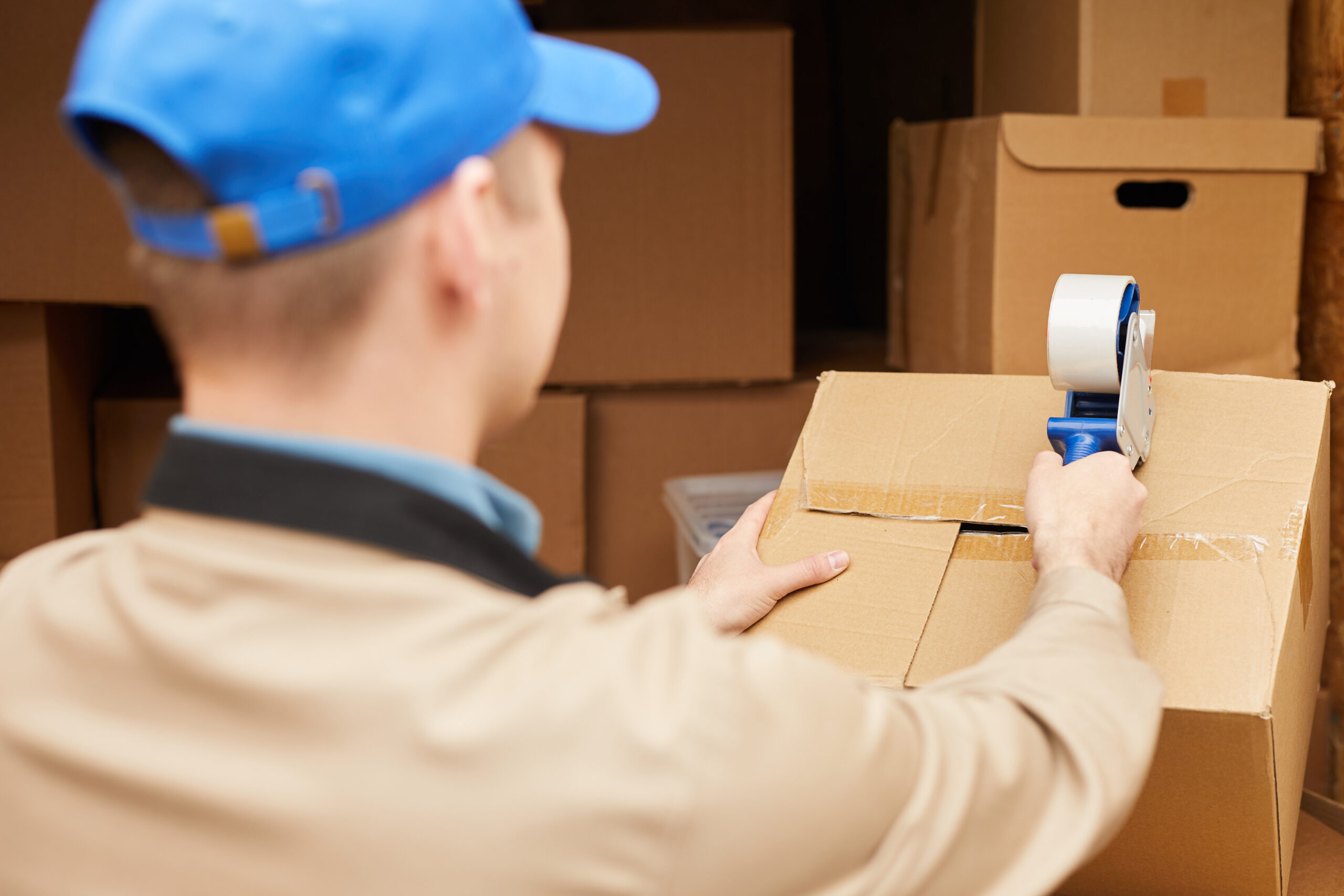 A man packing boxes to help with your move. We offer packing services near Dayton, Ohio and beyond