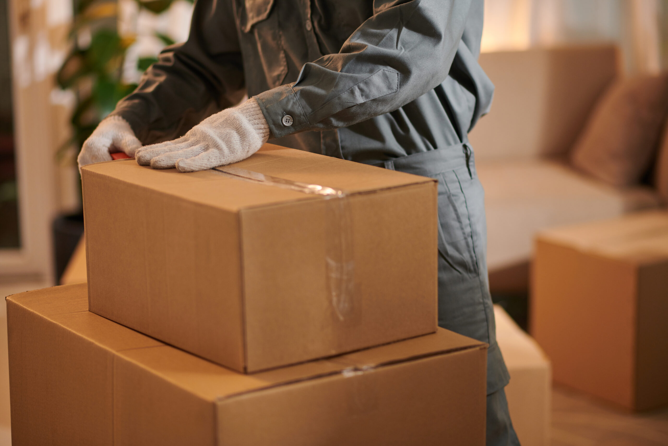 A mover packing boxes to assist customers with packing services near Dayton, Ohio and beyond